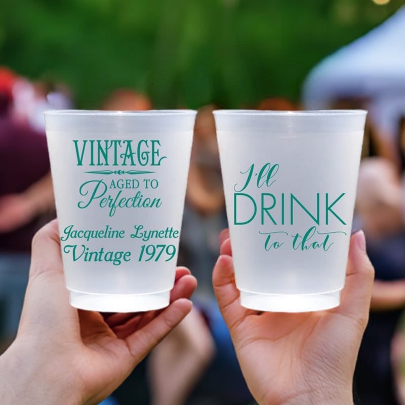 Frosted plastic glassware personalized with "Vintage Aged To Perfection" design and custom text on front side and "I'll Drink To That' design on back side in green print for adult birthday party cups.