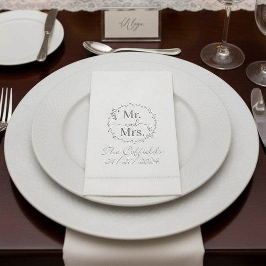 Elegant white linen feel hemstitch guest towel napkins on a wedding table setting