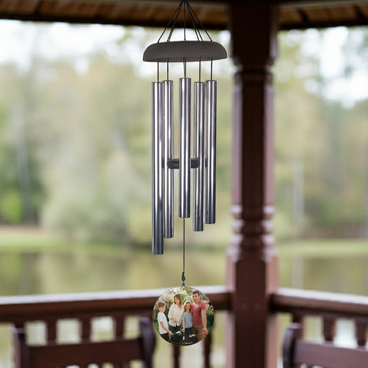 Wind chime personalized with photo wind sail hanging outdoors near blooming tree