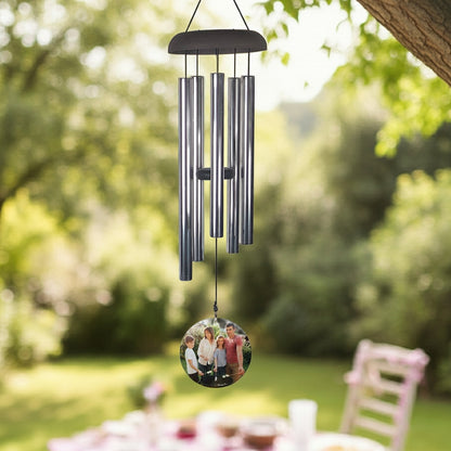 Wind chime personalized with photo wind sail hanging outdoors near window and plants