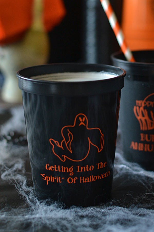 Black 16 oz. stadium cups personalized with 'Ghost' Halloween design and 2 lines of text in orange imprint color