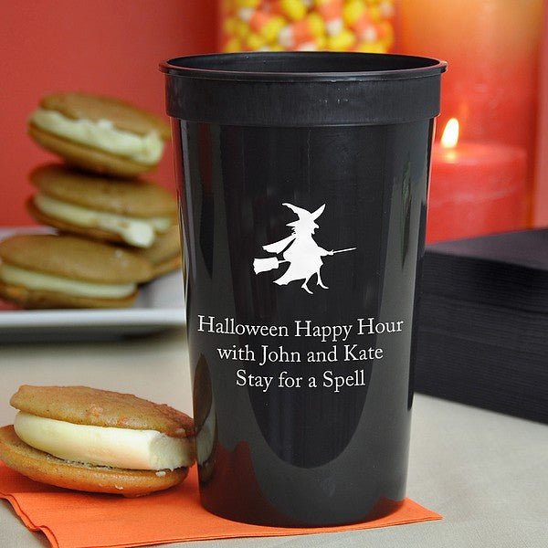 22 Oz. black stadium cup personalized with 'Witch & Broom' Halloween design and 3 lines of text in black imprint color