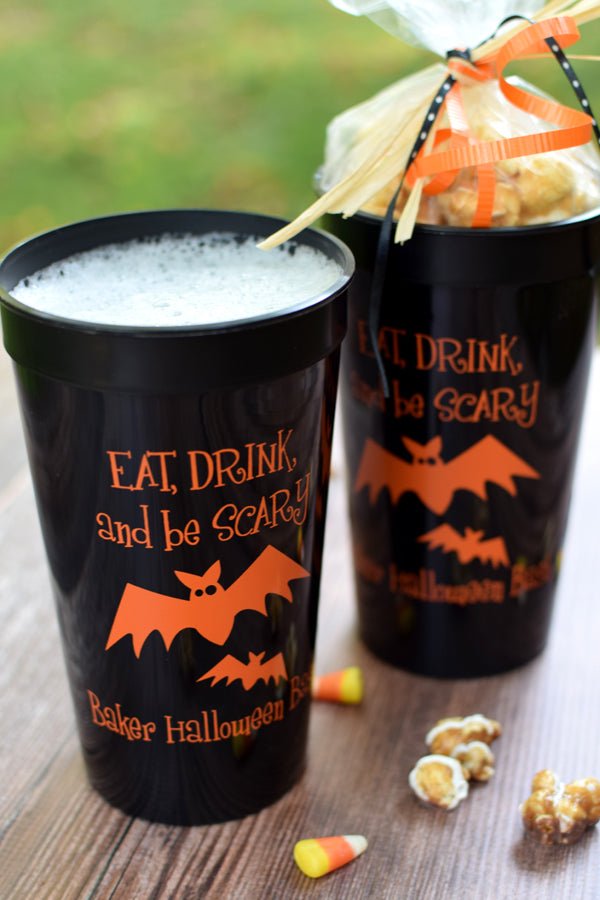 Black 32 ounce jumbo stadium cups personalized with 'Eat, Drink and Be Scary' Halloween design and 1 line of text in orange imprint color