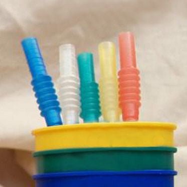 Natural, red, yellow, green and blue flexible plastic straws in 16 ounce size stadium cups.