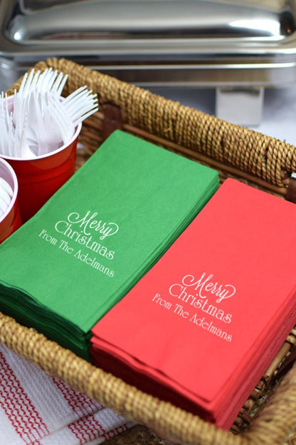 Red and green 3-play paper guest hand towels personalized with 'Merry Christmas' design and 1 lines of custom text in Ivory imprint color for holiday dinner table or wash room